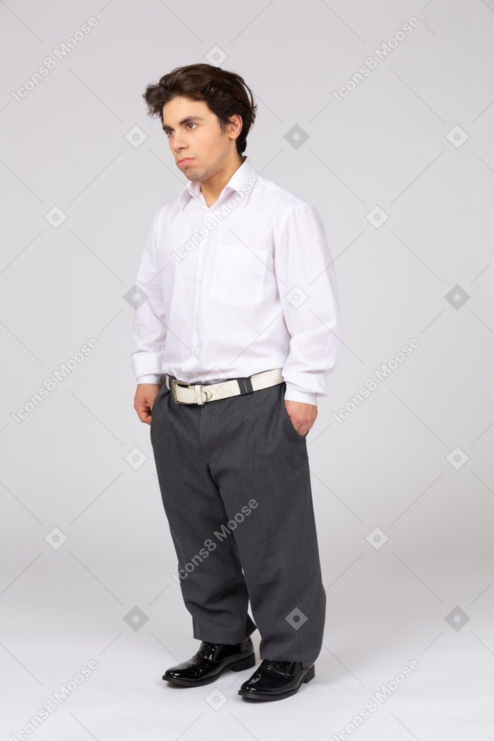 Three-quarter view of an office worker holding hands in pockets
