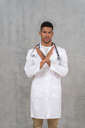 Male doctor making a stop gesture