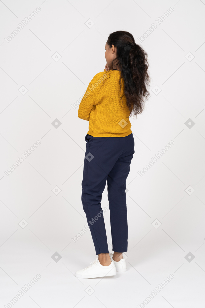Rear view of a thoughtful girl in casual clothes
