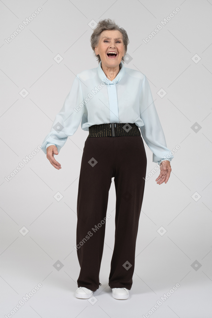 Front view of an old woman laughing heartily