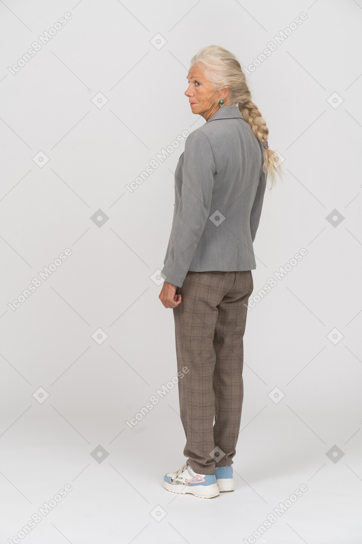 Rear view of an old woman in suit