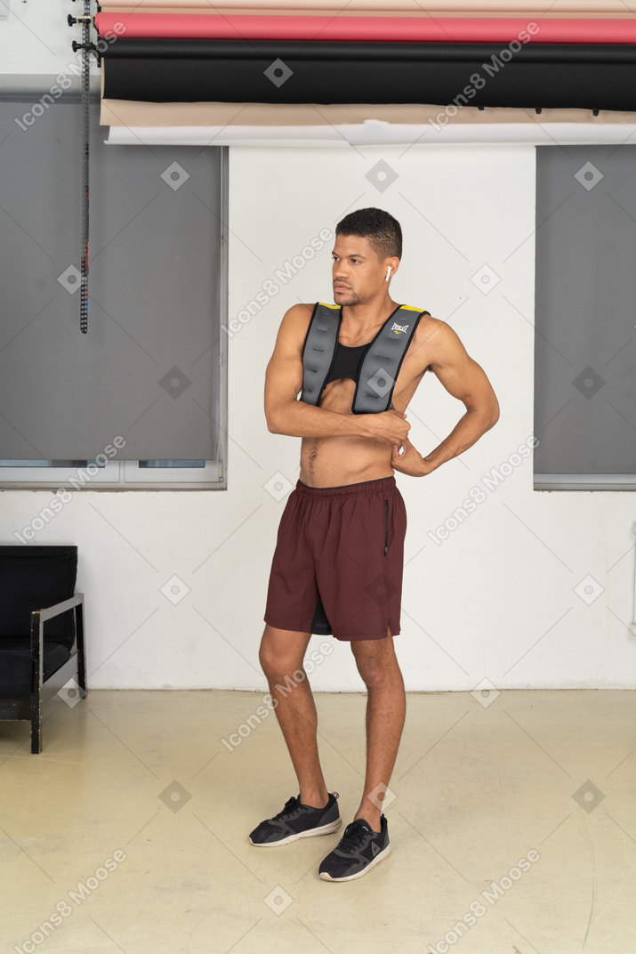 Young man adjusting weighted vest