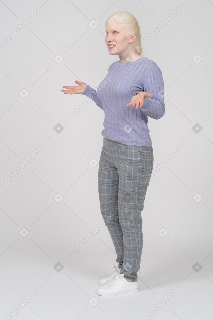 Confused young woman spreading arms