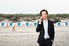 A man in a suit talking on a cell phone
