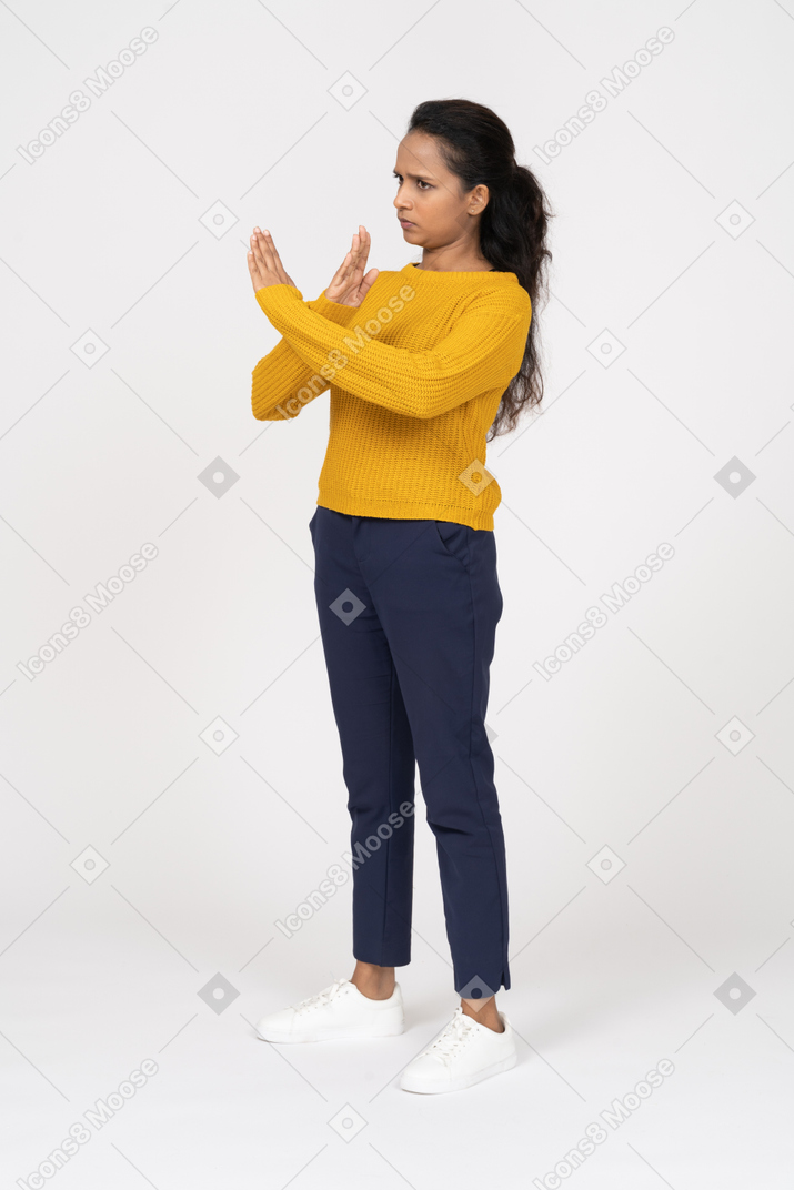 Side view of a girl in casual clothes showing stop gesture