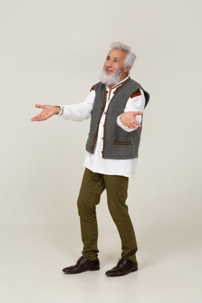 Man in gray vest standing with arms open