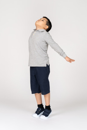 Boy jumping with spread arms