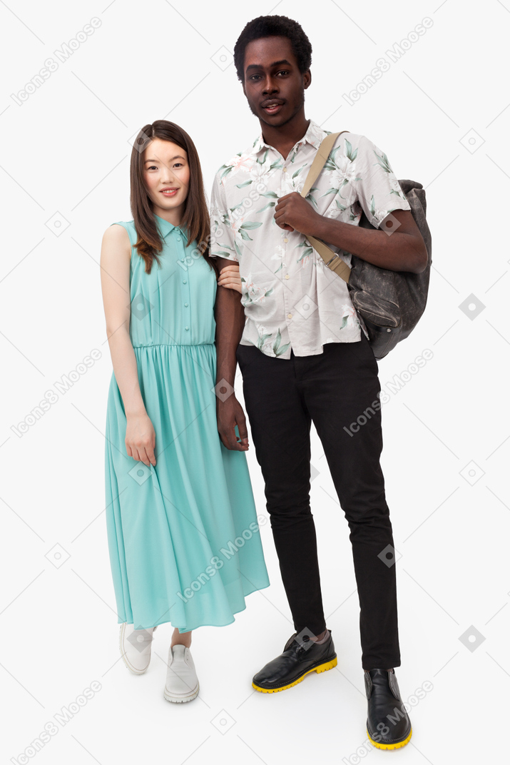 Asian woman holding her afro partner by arm