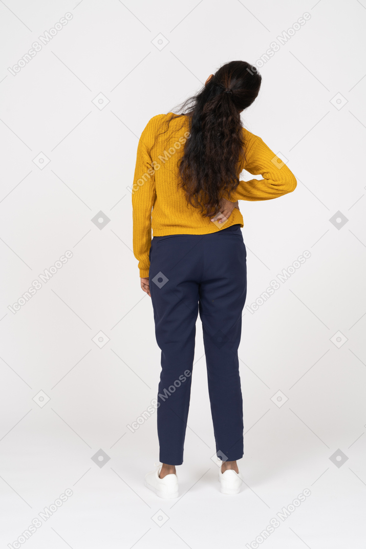 Rear view of a girl in casual clothes stretching