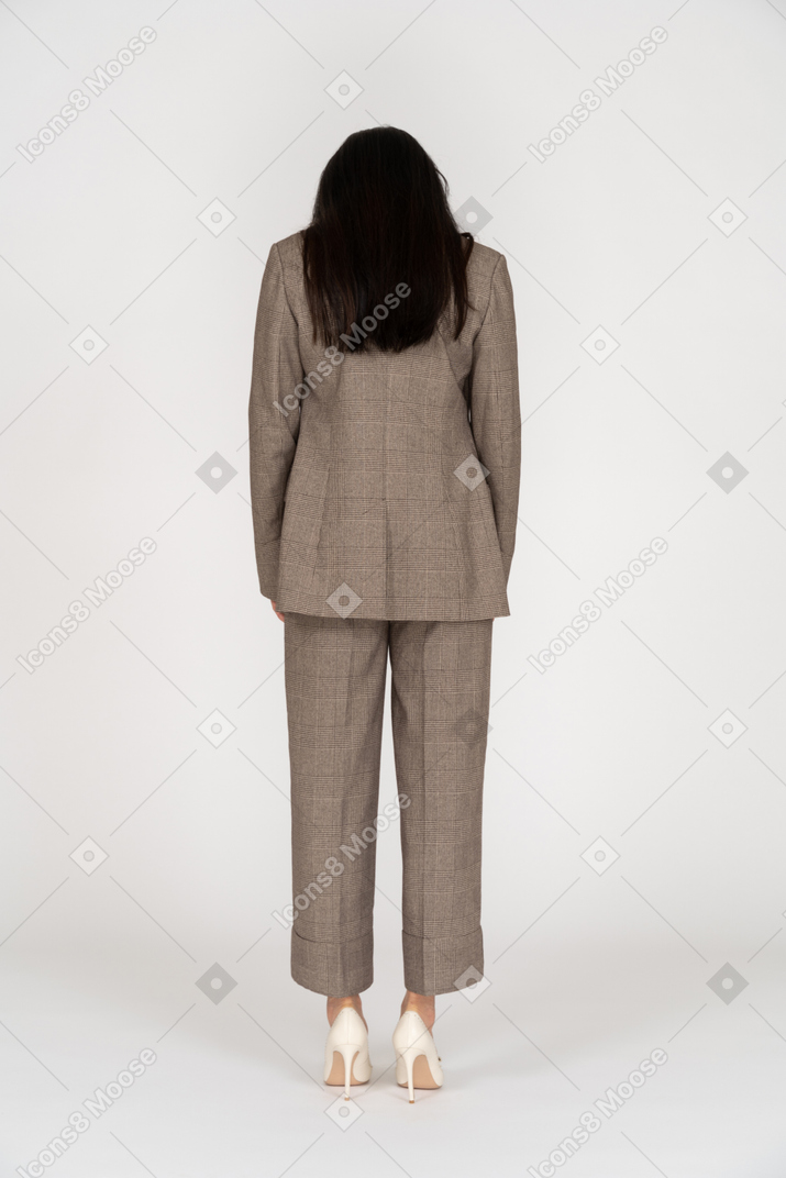 Back view of a young lady in brown business suit looking down