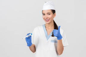 Attractive nurse showing a digital thermometer