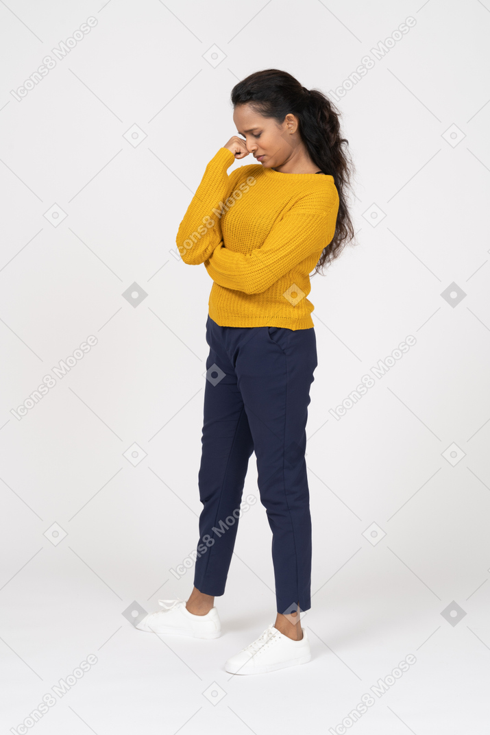 Upset girl in casual clothes standing in profile