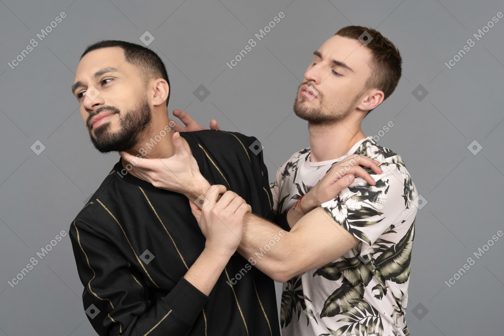 Young caucasian man trying to turn the other one's head back to him by the neck
