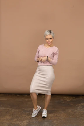 Front view of a woman in casual clothes looking at camera and making faces