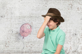 Frustrated boy wearing cowboy hat