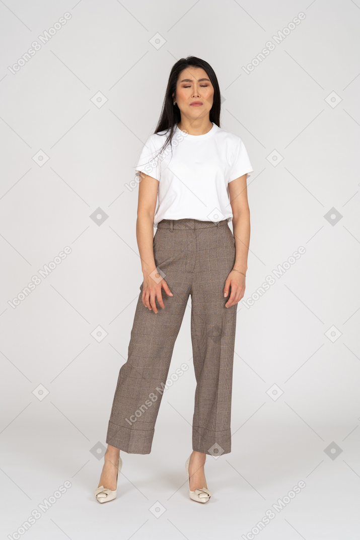 Front view of a crying young lady in breeches and t-shirt