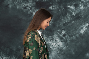 Side view of shy smiling businesswoman in japanese jacket