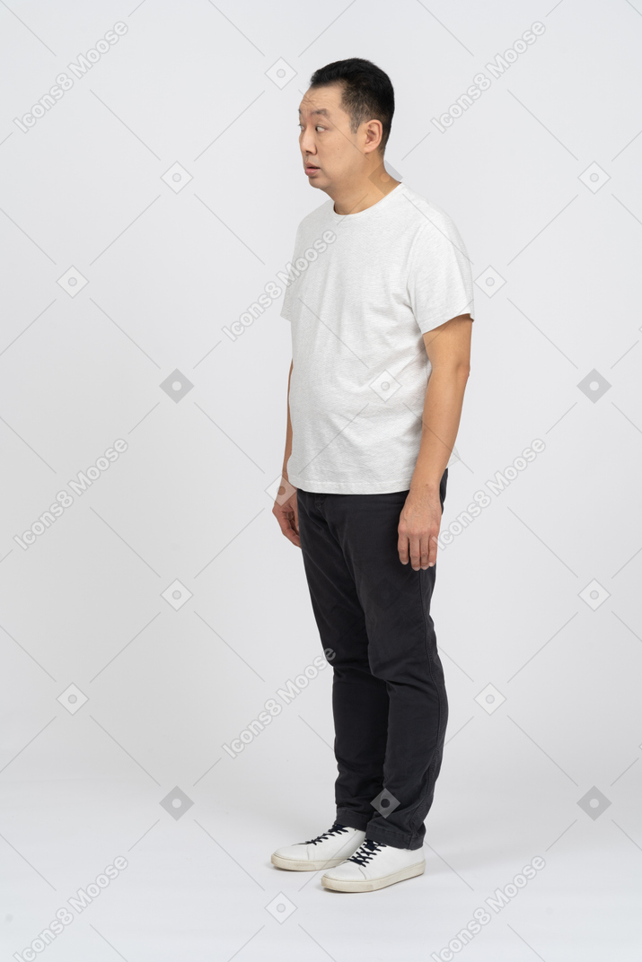 Man in casual clothes looking at something with interest