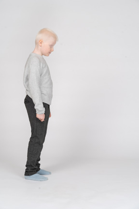 Vista lateral de um menino em pé