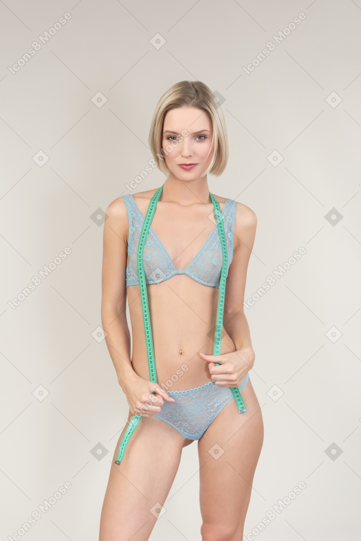 Sexy young woman with cloth tape measure on her neck