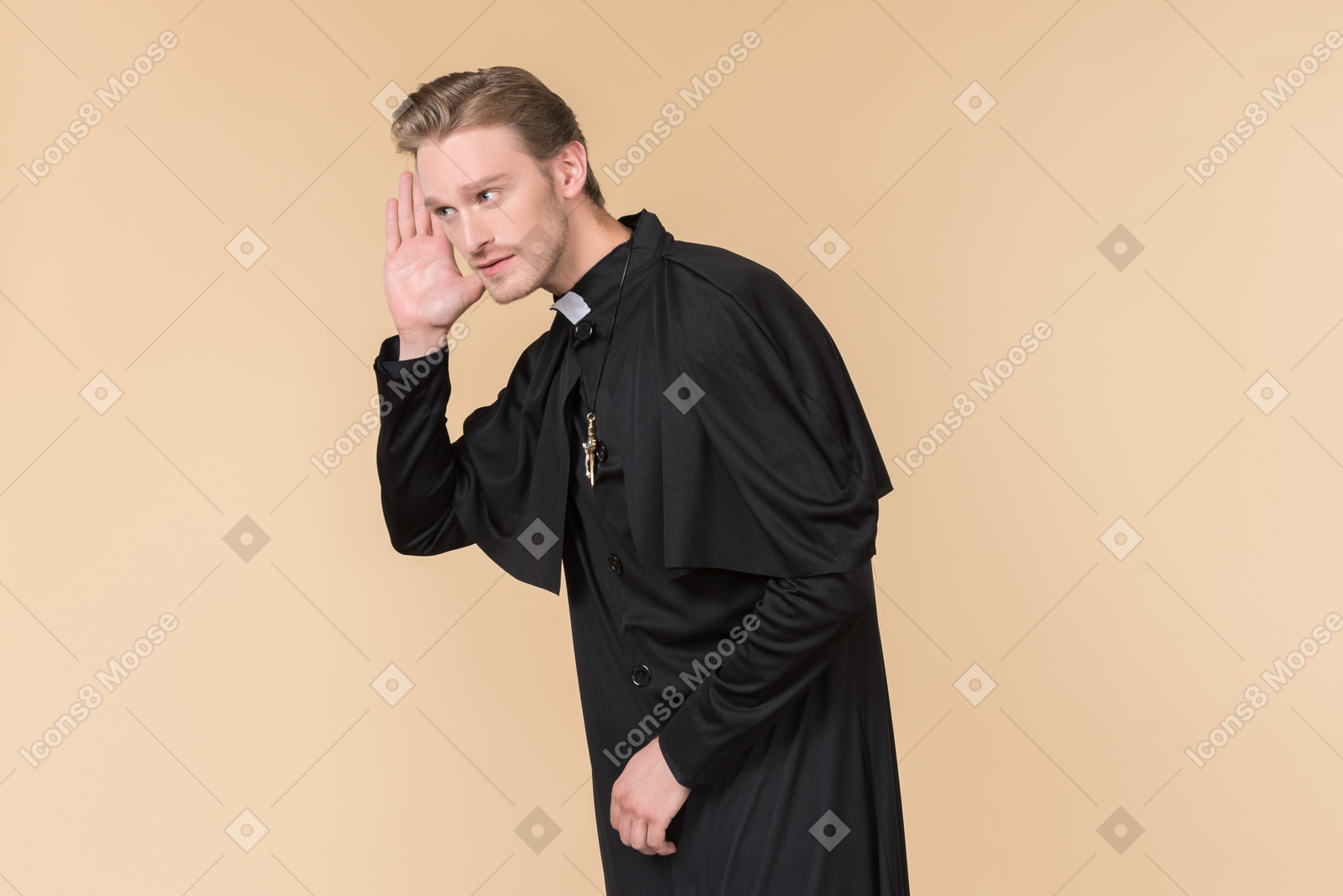 Catholic priest holding hand close to an ear and listening carefully