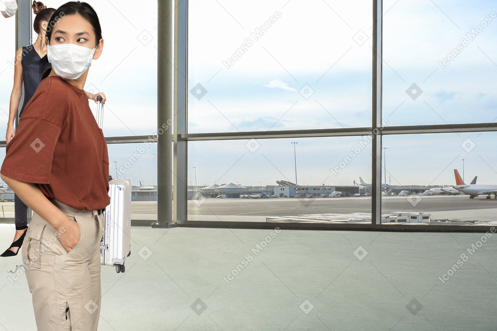 Two women standing in an airport