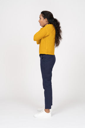 Side view of a girl in casual clothes chocking herself