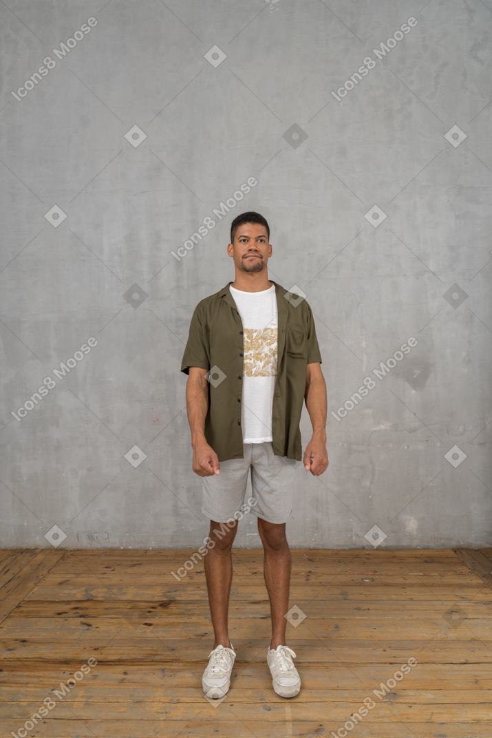 Confused man standing with arms at sides