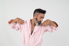 Man in bathrobe stretching