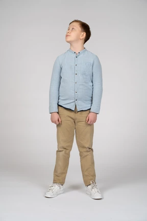 Front view of a boy in casual clothes looking up