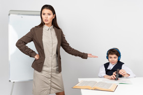 Angry young teacher and ignoring student