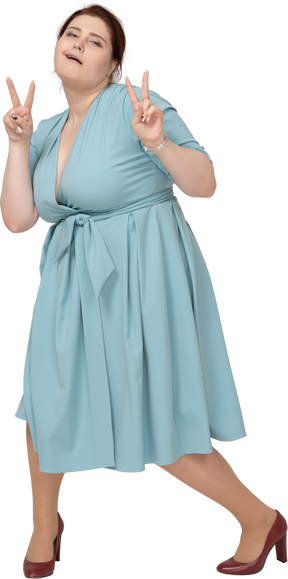 Vue de face d'une femme en robe bleue montrant des signes v