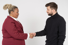 Office workers greeting each other with a handshake