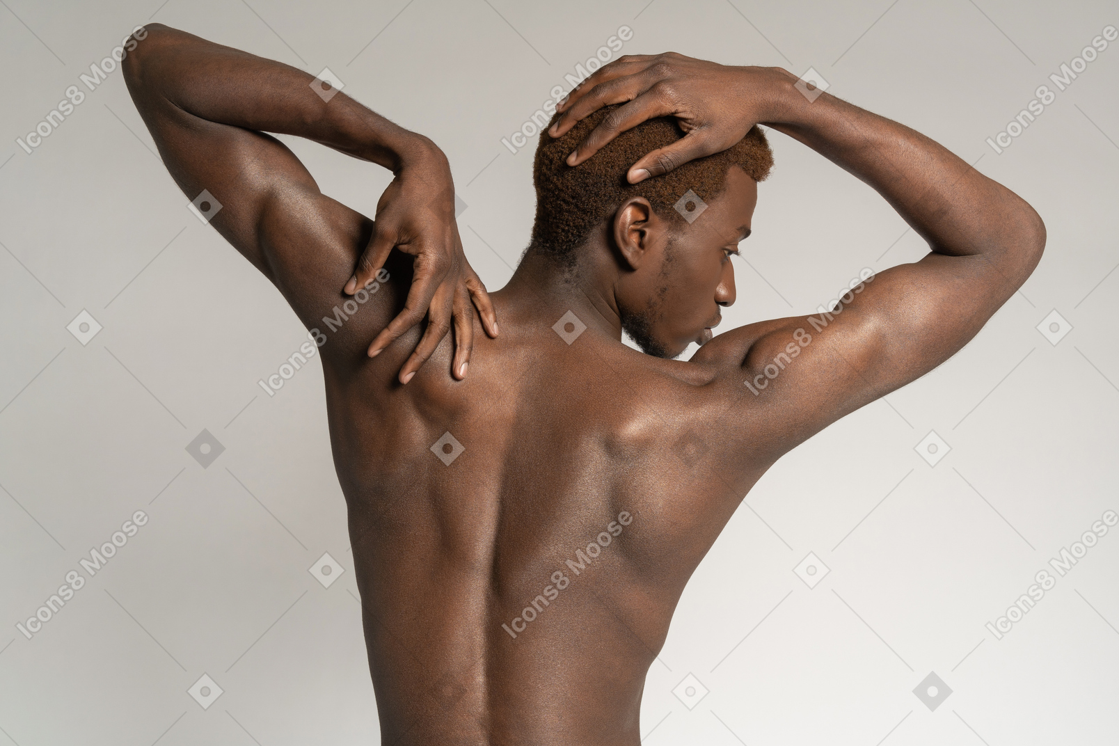 Topless man touching back and head