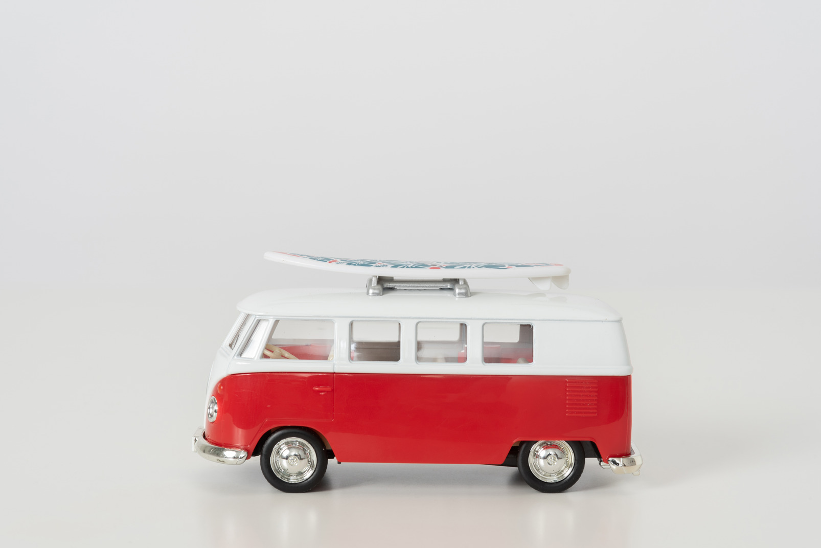 Toy hippie autobus in profile on grey background