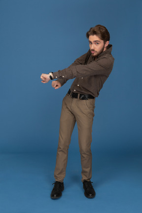 A dancing slim young man looks to camera