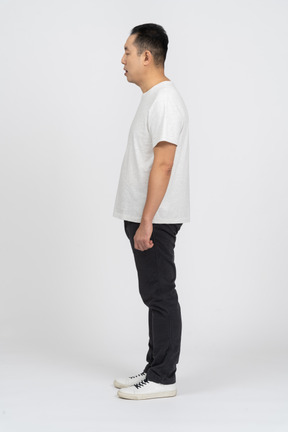 Man in casual clothes standing in profile