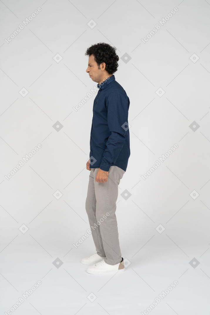 Man in casual clothes standing in profile