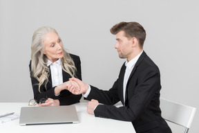 An older woman and a young man working together