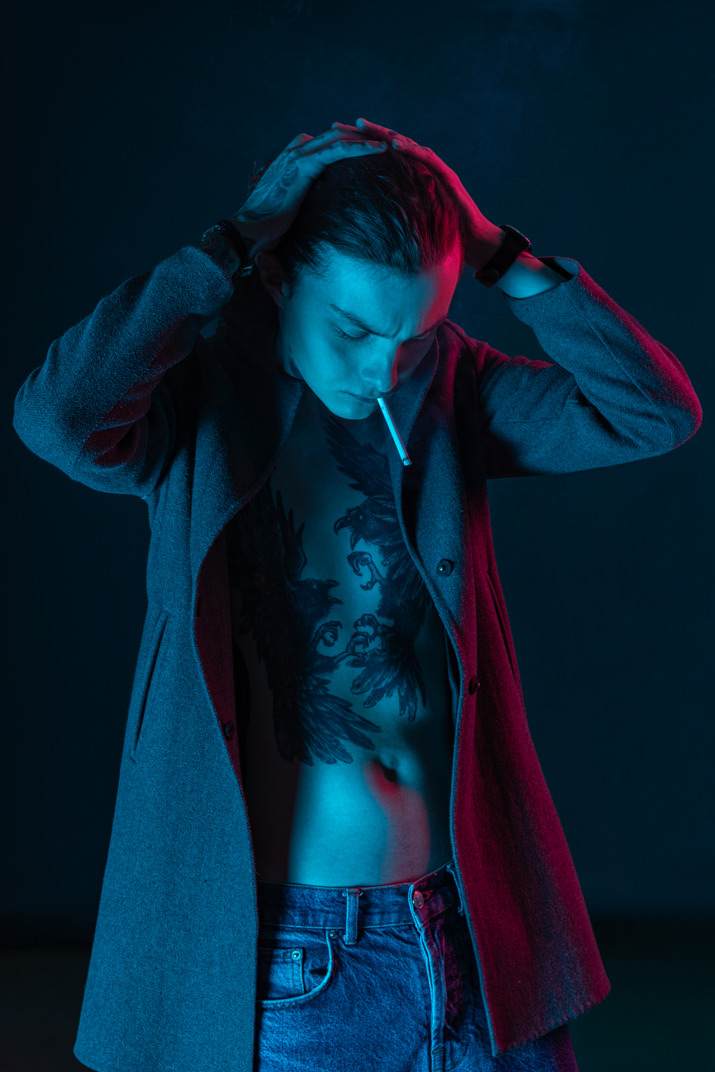 Male model on the dark background looking down