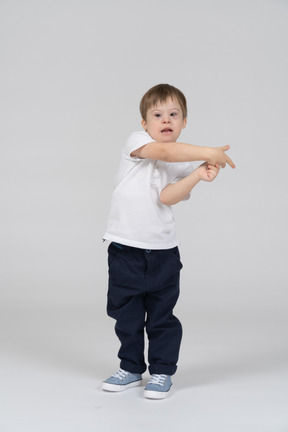 Little boy swaying and pointing sideways