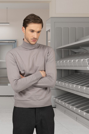 A man standing next to empty shelves in a supermarket