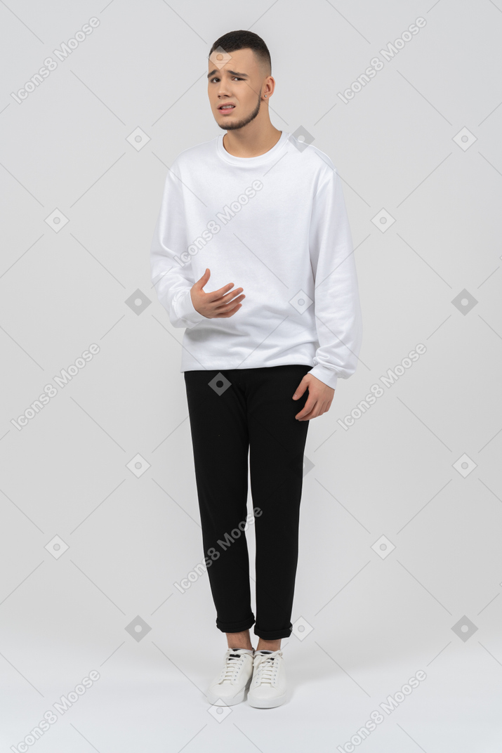 Confused young man standing