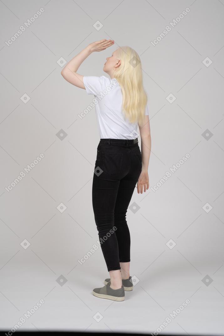 Back view of girl covering face from sun