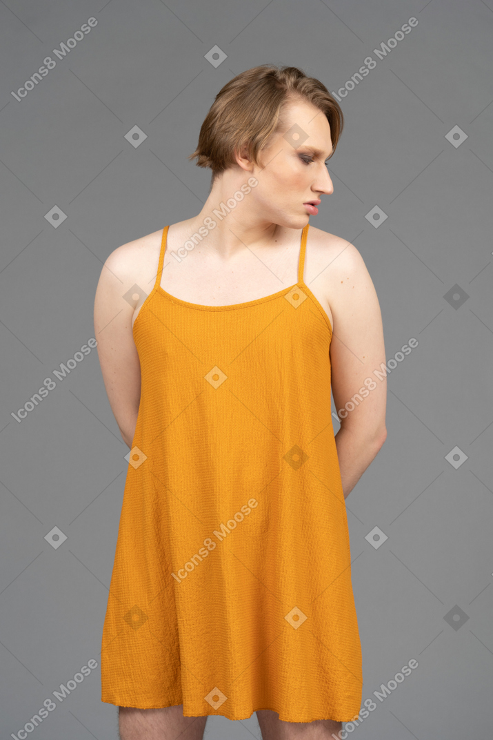 Transgender person posing with hands behind their back
