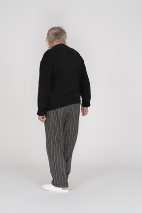 Back view of elderly man turning away from camera