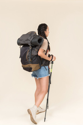 Hiker woman walking using trekking poles