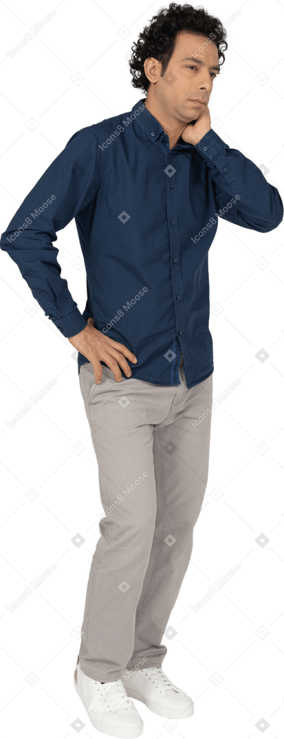 Front view of a man in casual clothes thinking about something