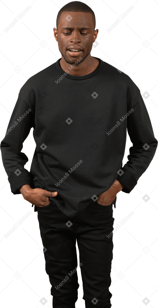 Man holding his hands in pockets and looking down