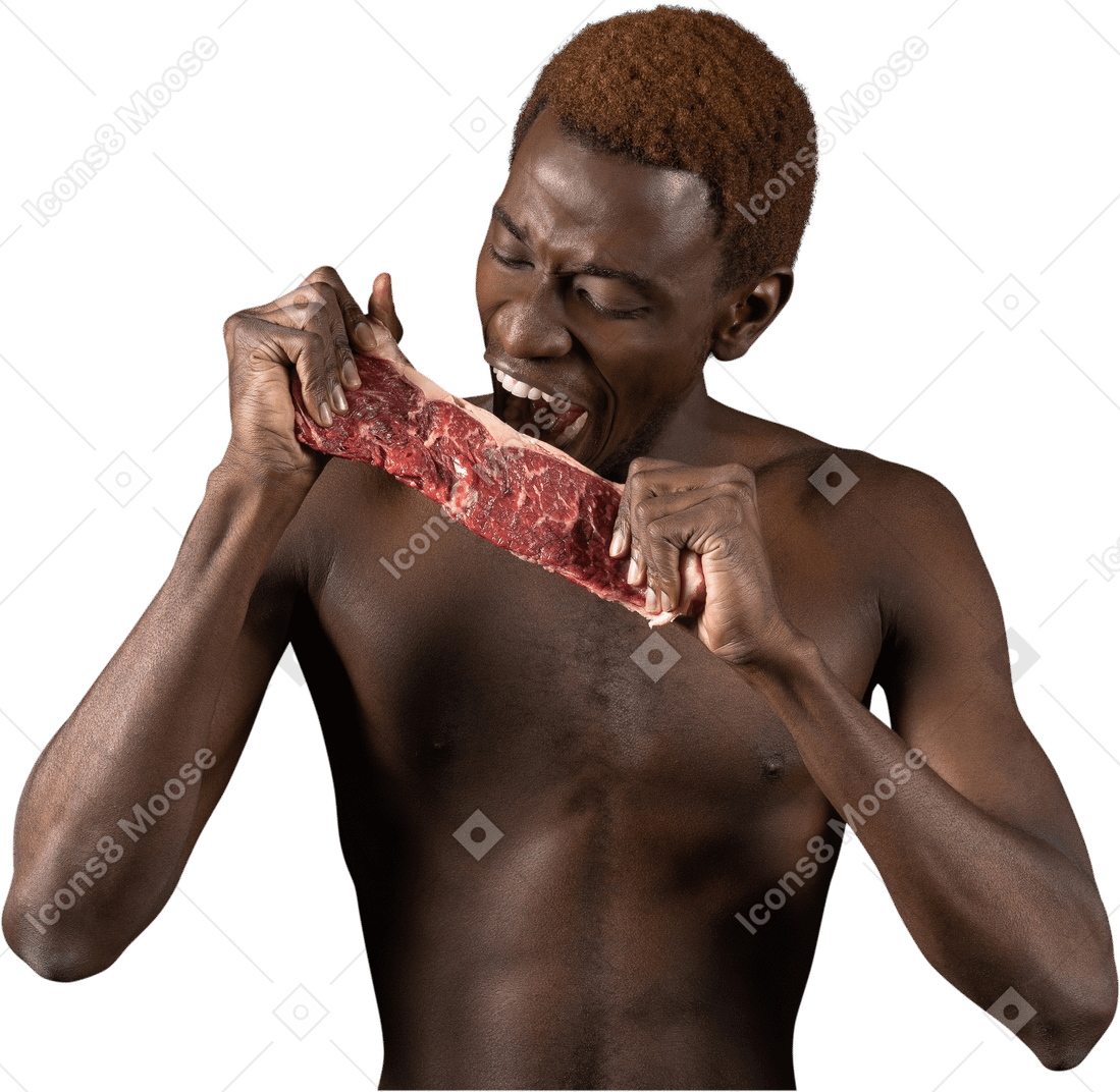 Front view of a young afro man biting a slice of meat